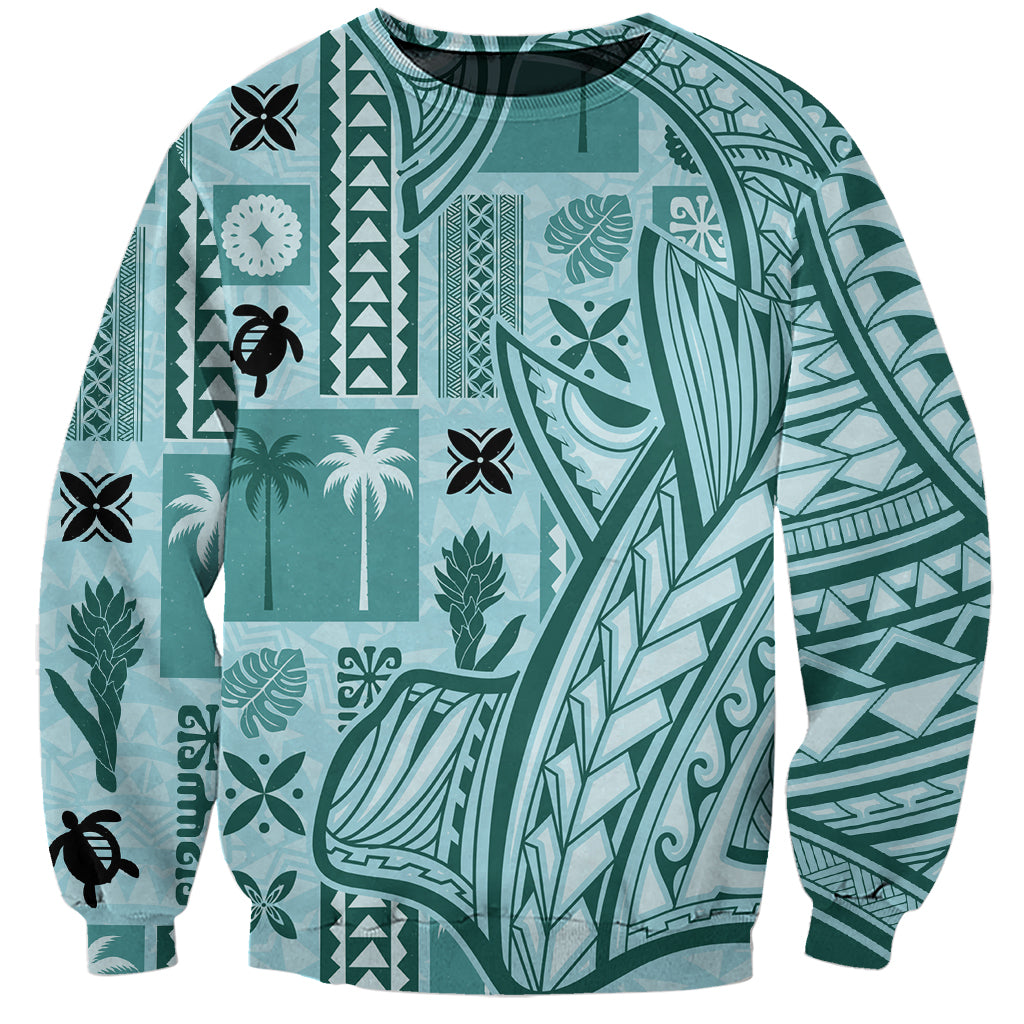 Unisex teal tapa-pattern sweatshirt with crew neck and long sleeves, patchwork graphic.