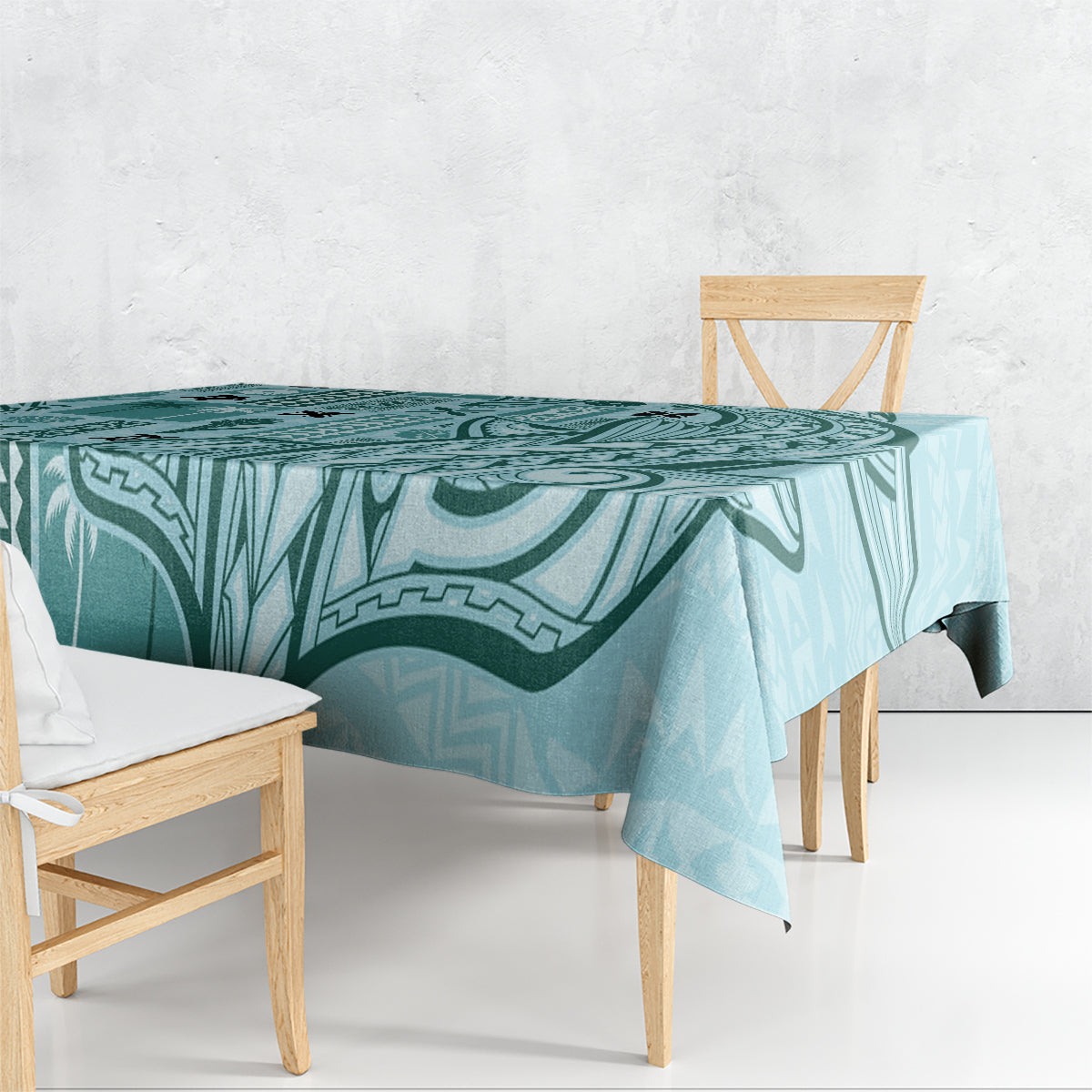 Teal geometric tapa-pattern tablecloth draped over dining table