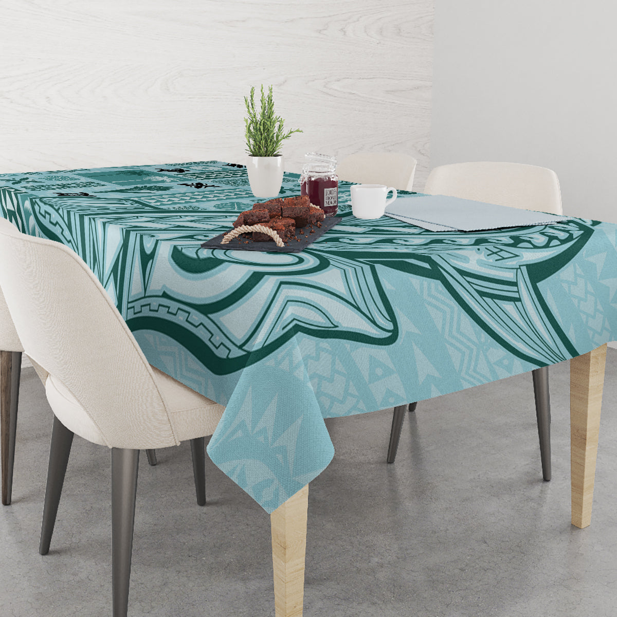 Teal tapa-pattern tablecloth on dining table with place setting