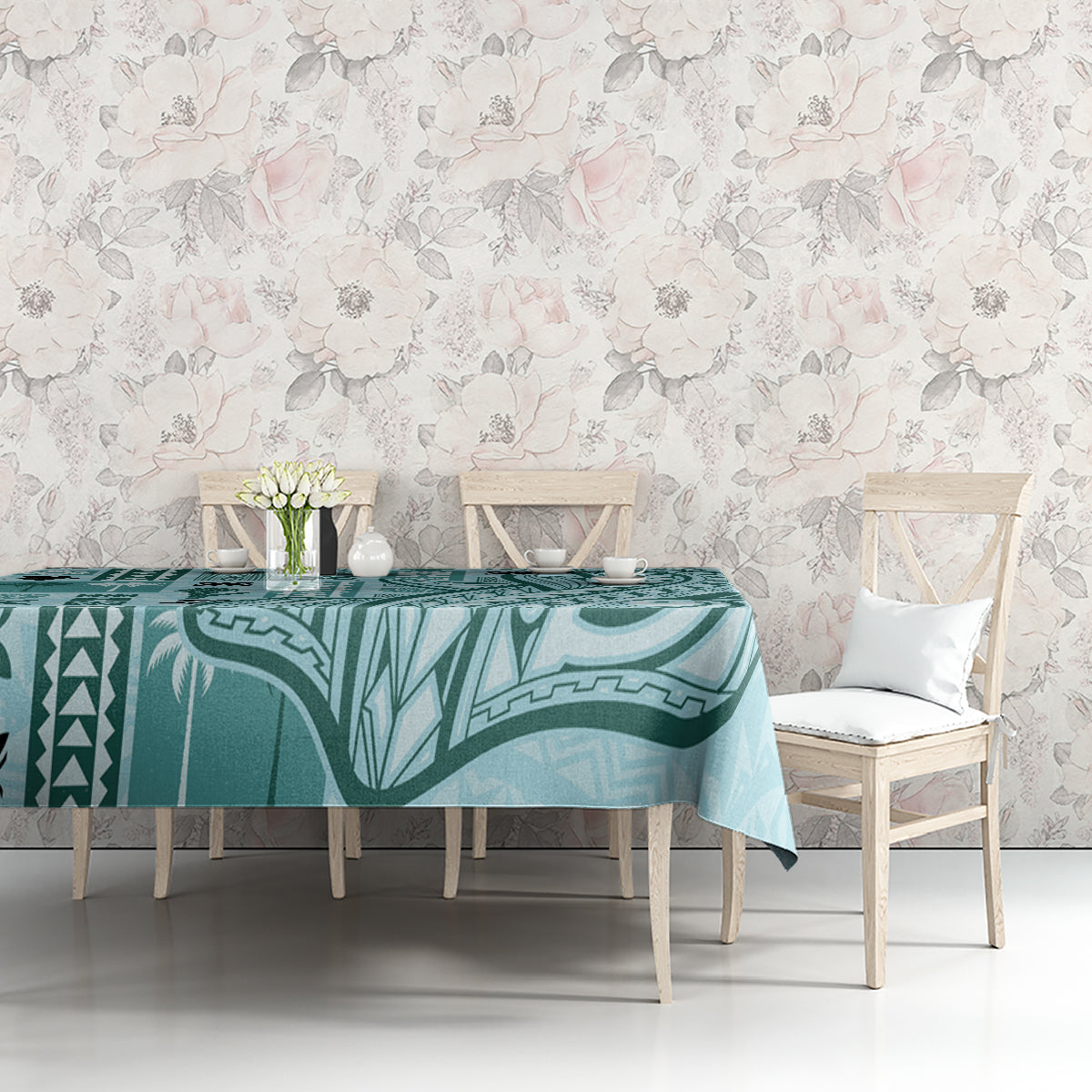 Teal tapa-pattern tablecloth on dining table with two white chairs