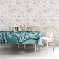 Teal tapa-pattern tablecloth on dining table with two white chairs