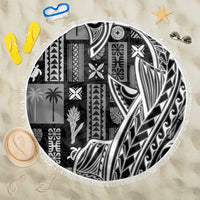Round beach blanket with black-and-white tapa/tatau patterns and white fringe edge.