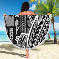 Round beach blanket with black-and-white tapa/tatau motifs and white fringe border.