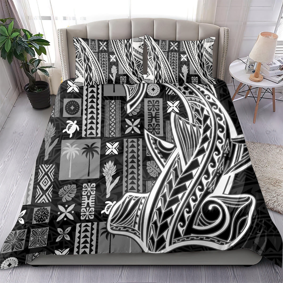 Black and white tapa-pattern bedding set with feather and swirl motifs on bed