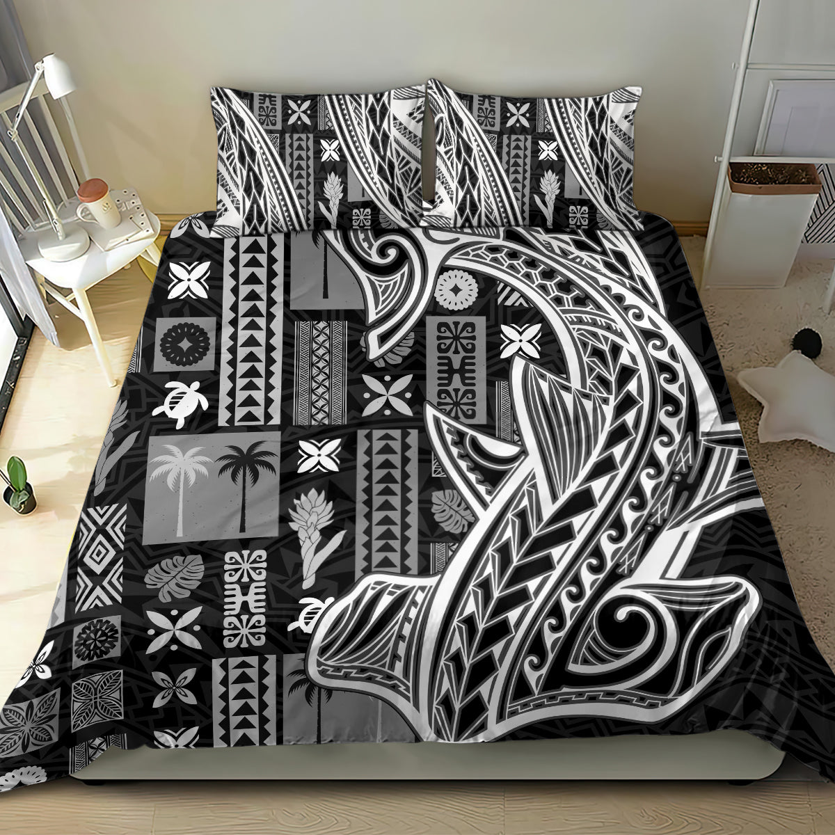 Black and white tapa-pattern bedding set with patchwork geometric squares on bed