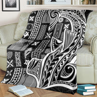 Samoan tapa-style throw blanket on armchair with black-and-white tribal tatau artwork