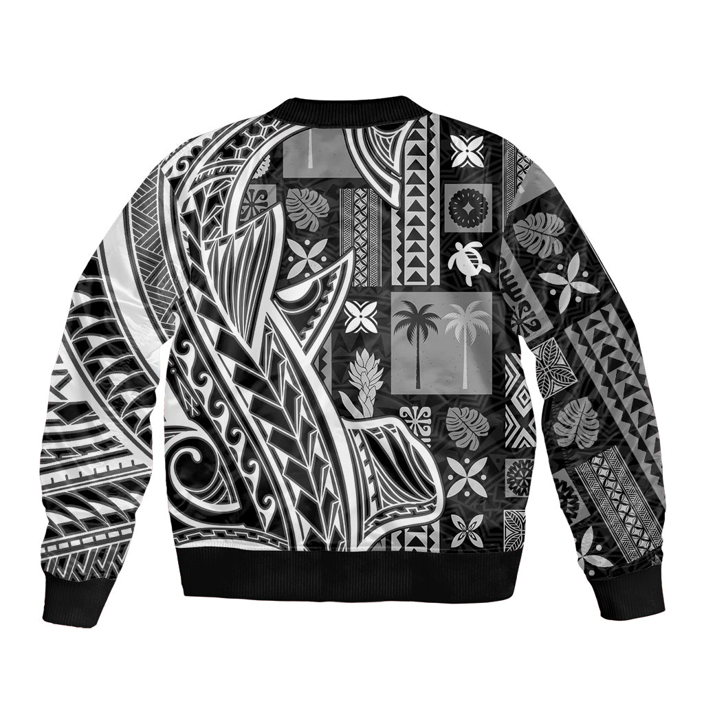 Black unisex bomber jacket with black-and-white tapa-style patchwork patterns, ribbed hem