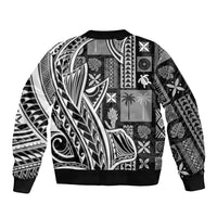 Black unisex bomber jacket with black-and-white tapa-style patchwork patterns, ribbed hem