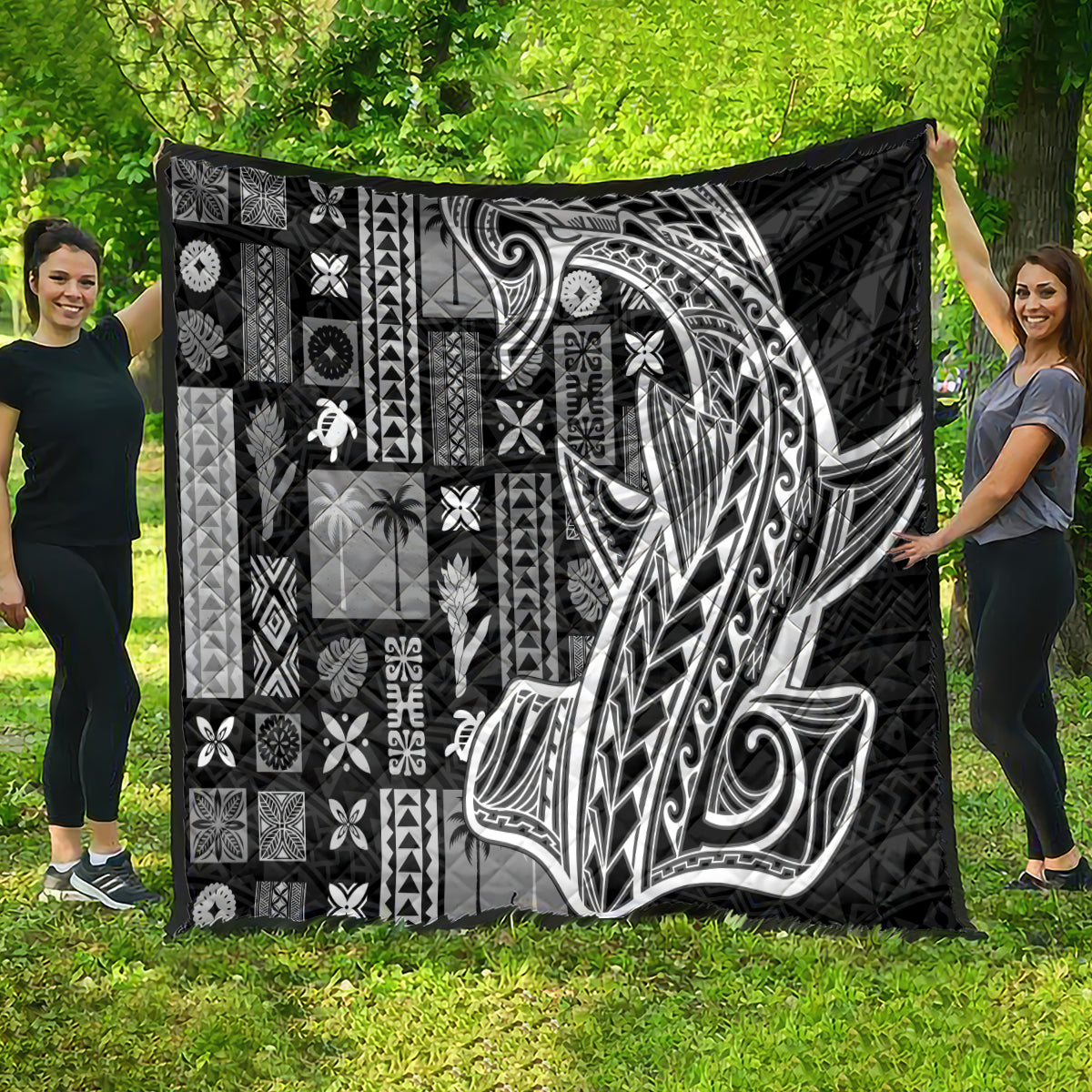 Black Samoa tapa quilt with bold Tatau-style face motif and patchwork tiki icon blocks