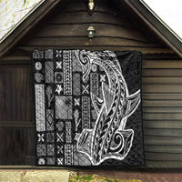 Black Samoa tapa quilt displayed on a porch wall with Tatau-style face center design
