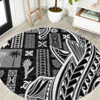 Black round tapa pattern carpet with bold white tribal motifs and curved edge border