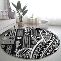 Black round tapa round rug with large leaf and geometric tribal patterns in white