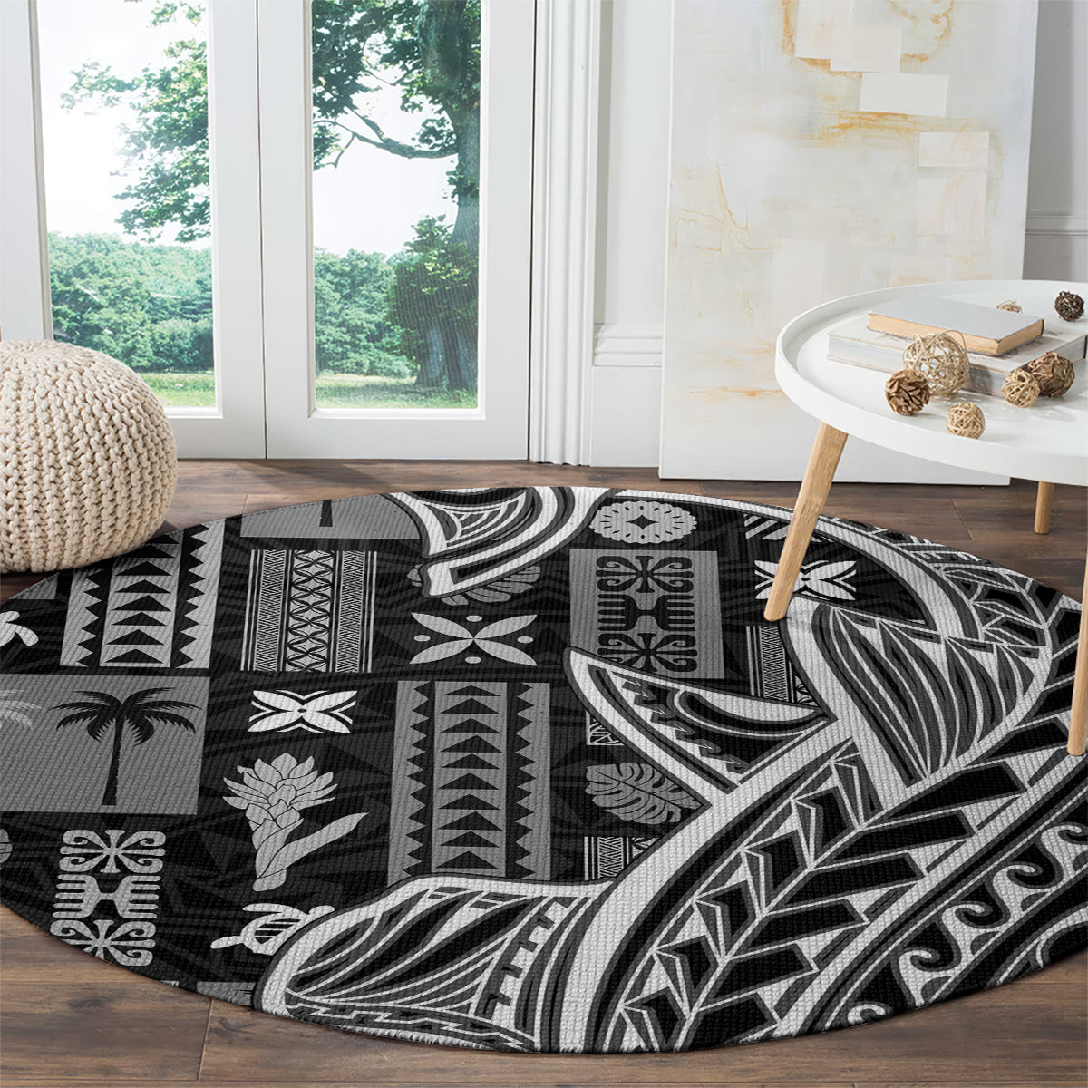 Black round carpet with dense geometric tapa and leaf motifs in white and gray