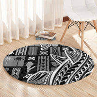 Black round tapa rug with patchwork tribal blocks and leaf design in white and gray