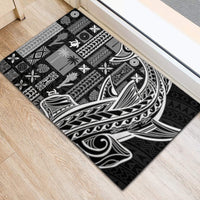 Rectangular black rubber doormat featuring white and gray tribal Tapa siapo artwork
