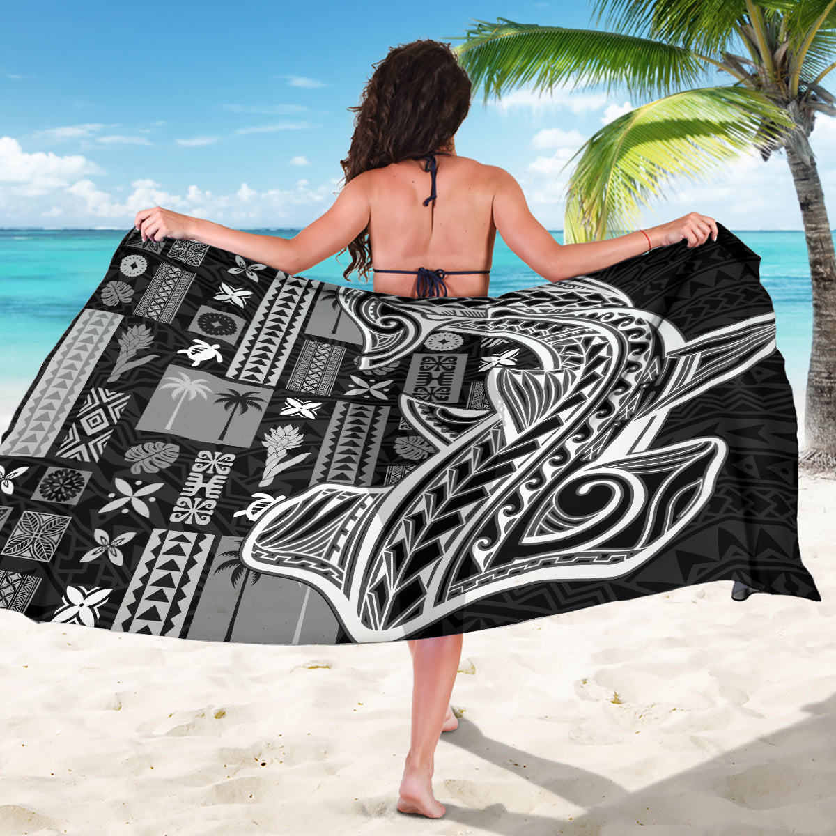 Black and white tapa sarong featuring large central bird motif with geometric blocks