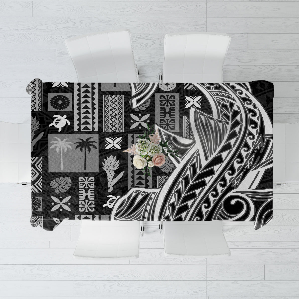 Black tapa patterned tablecloth with abstract tribal motifs, rectangular drape over table