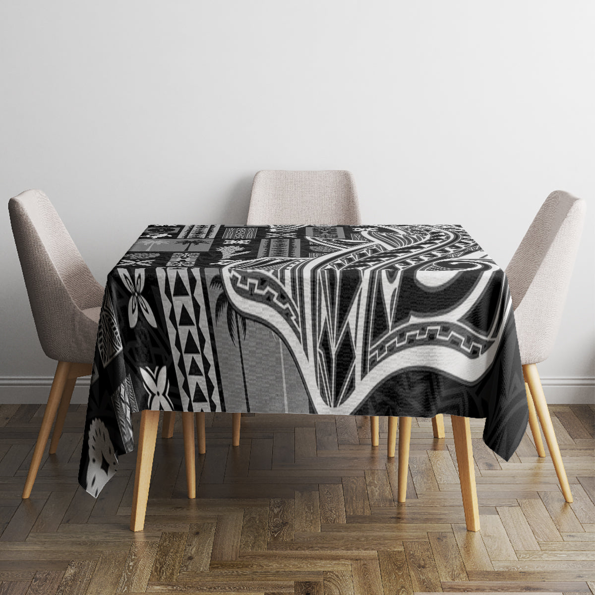 Black tapa patterned tablecloth on dining table with four beige chairs, full coverage