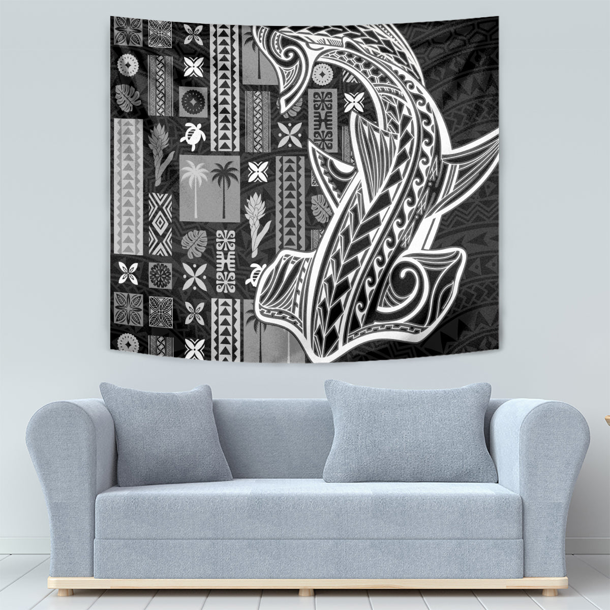 Black and white tapa pattern wall tapestry, rectangular, mounted above sofa.