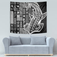 Black and white tapa pattern wall tapestry, rectangular, mounted above sofa.