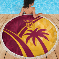 Round maroon and yellow tropical beach blanket with fringed edge and bold palm '07' artwork.