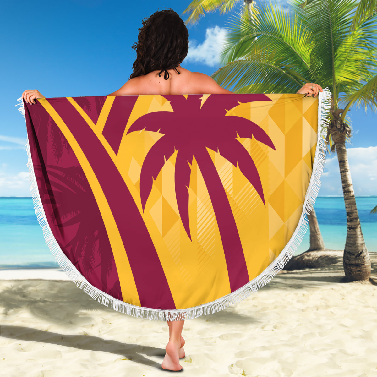 Round maroon and yellow tropical beach blanket, fringed border, large palm and '07' print.