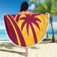 Round maroon and yellow tropical beach blanket, fringed border, large palm and '07' print.