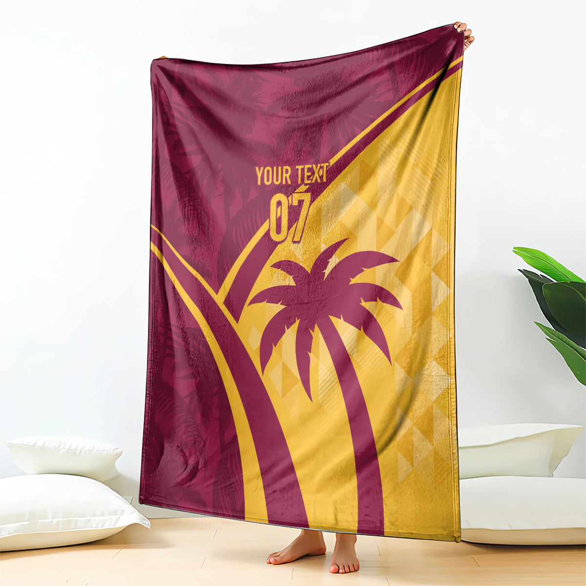 Maroon and yellow tropical blanket hanging upright, palm tree and “07” graphic