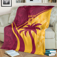 Maroon and yellow tropical style blanket draped on a sofa, palm tree and “07”