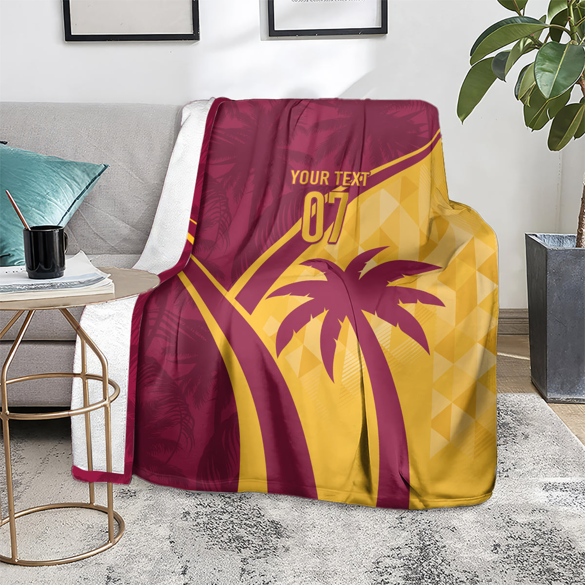 Maroon and yellow tropical blanket folded on a couch with palm tree and “07”