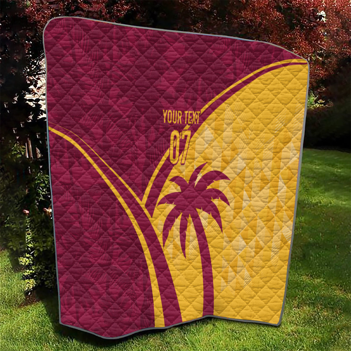 Maroon and yellow quilt with diamond stitching, cricket emblem and custom text on display