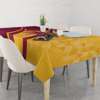 Maroon and yellow tropical cricket tablecloth on dining table with geometric pattern.