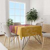 Maroon and yellow tropical cricket tablecloth covering dining table, geometric pattern.