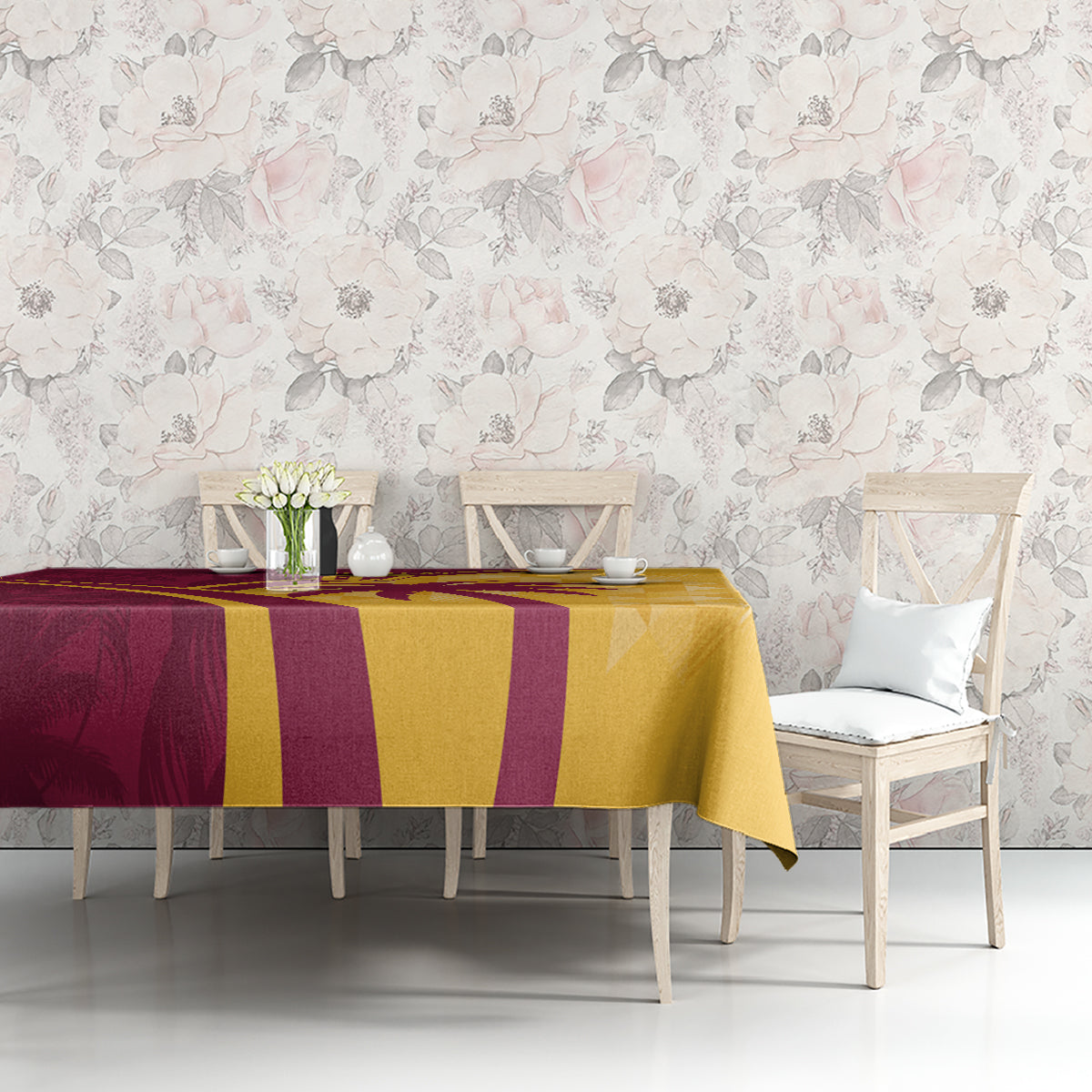 Maroon and yellow tropical cricket tablecloth on dining bench, geometric and palm-leaf design.