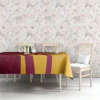 Maroon and yellow tropical cricket tablecloth on dining bench, geometric and palm-leaf design.