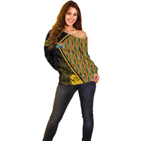 Off-shoulder sweater with diagonal kente grid and gold floral graphics, long sleeves