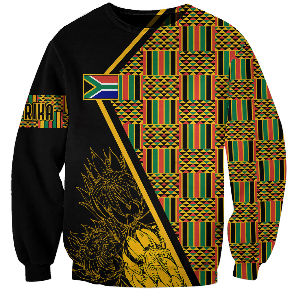 Black kente-pattern sweatshirt with gold floral protea graphic and geometric panel