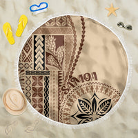 Round beige beach blanket with brown Polynesian motif and white fringe edge