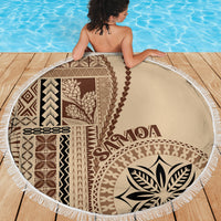 Round beach blanket showing full brown and beige Samoan pattern with white tassel trim