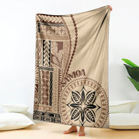 Beige siapo motif blanket with brown geometric panels and central leaf emblem