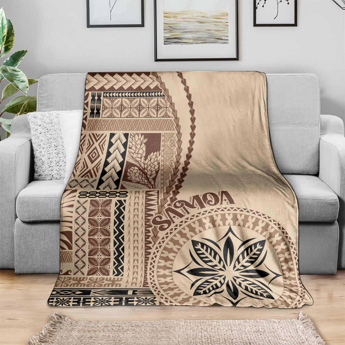 Beige motif blanket draped over sofa, brown geometric pattern and large flower-leaf emblem