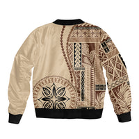 Beige bomber jacket with black ribbed collar and cuffs; Polynesian motif patchwork back
