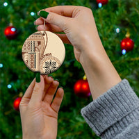 Beige siapo motif ceramic ornament, round shape held by hand with gold hanging cord