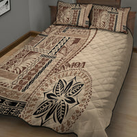 Beige quilt bed set with quilted diamond pattern and large leaf emblem, plus 2 pillows