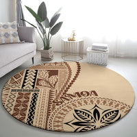 Beige round rug with bold brown geometric motifs and large leaf emblem in center