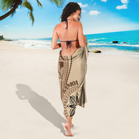 Beige Samoa siapo motif sarong worn at back with leaf medallion and patterned hem