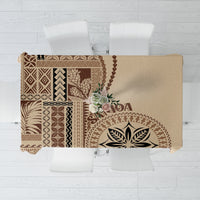 Beige tablecloth with brown Polynesian-style geometric leaf motifs and tassel trim edges