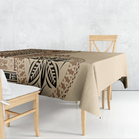 Beige tablecloth with bold brown leaf-and-tribal geometric motif, draped over dining table