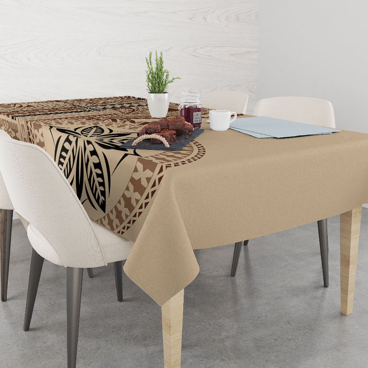 Beige tablecloth featuring large brown leaf motif and geometric bands, with straight table hang