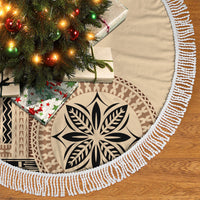 Beige round tree skirt with black leaf motif and white braided fringe edging, close-up